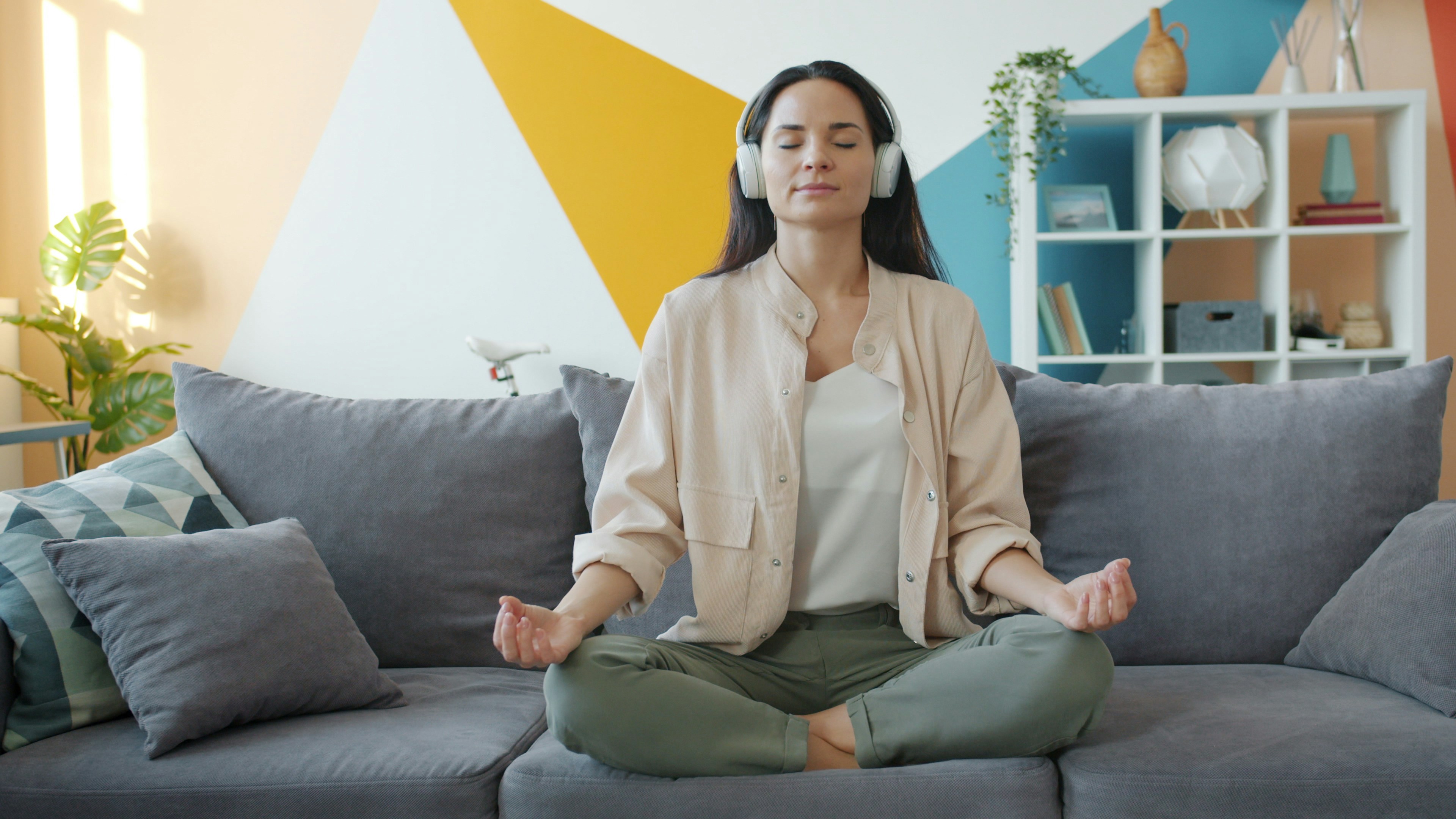 woman sitting on couch peacefully with eyes closed
